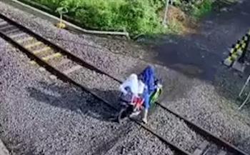 لحظة مروعة.. أم وأطفالها ينجون من موت محقق تحت عجلات القطار (فيديو) 