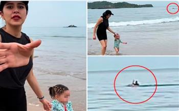 فيديو.. أم تستمتع مع ابنتها على الشاطئ وفي الخلفية سبّاح يصارع الموت  