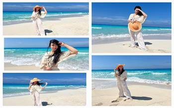 ميرهان حسين تتألق إطلالة صيفية باللون الأبيض على الشاطئ